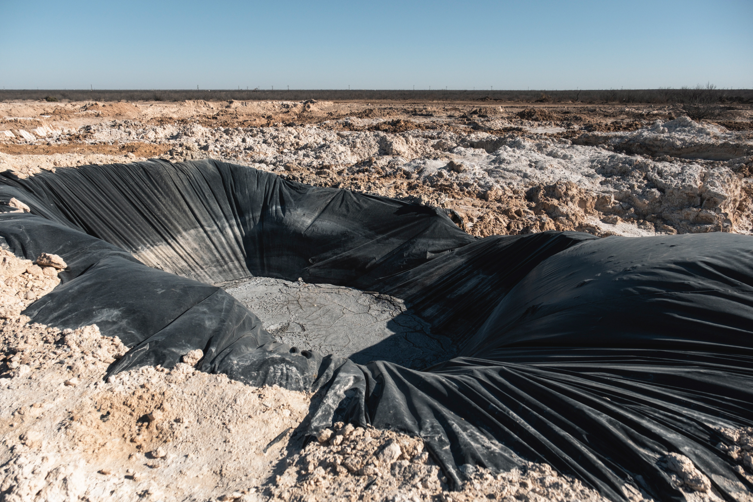 The Railroad Commission of Texas built similar pits in the surrounding area to collect the leaking water and haul it offsite. Credit: Sarah M. Vasquez/The Texas Tribune