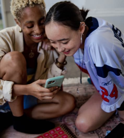 Two women looking at phone