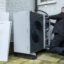 An air source heat pump repairman from Valiant replaces a Wilo pump inside an air source heat pump unit at a house in Folkestone, United Kingdom on Dec. 23, 2021. Credit: Andrew Aitchison/In pictures via Getty Images