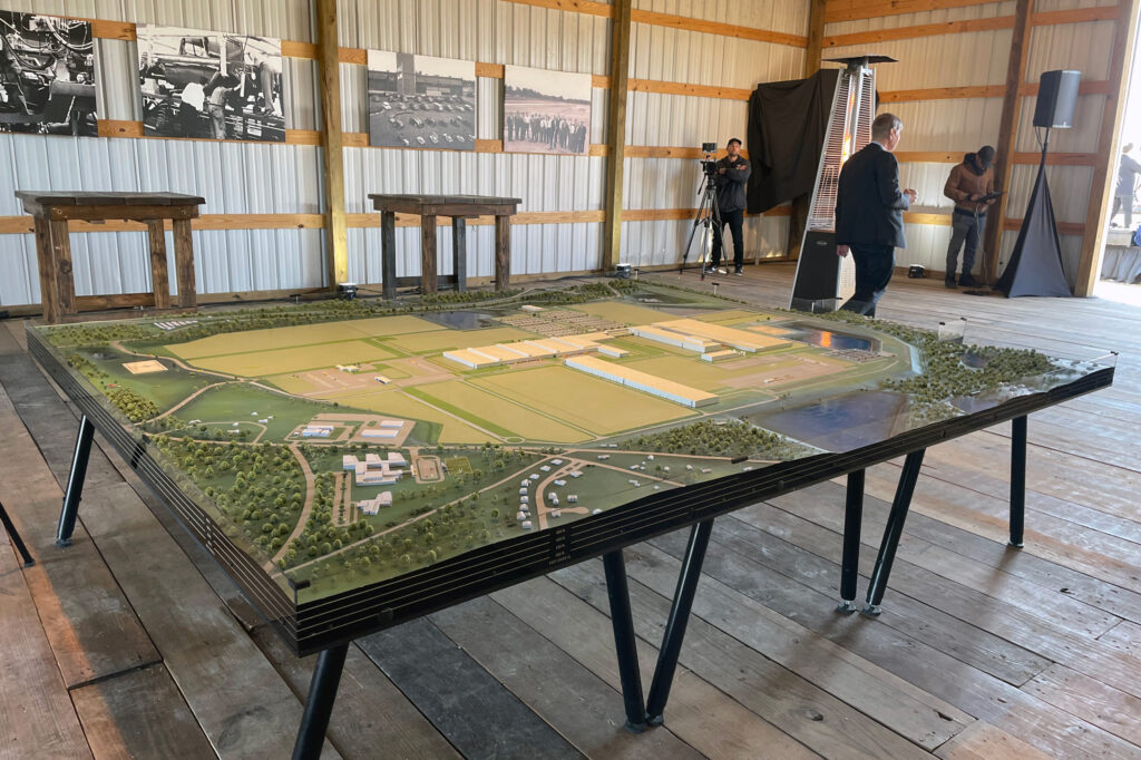 Scout Motors gave visitors a look at a scale model of the plant where the company hopes to produce up to 200,000 electric sport utility vehicles annually beginning in 2027. Photos of the original petroleum-powered Scouts lined the walls at the groundbreaking staging area Feb. 15. Credit: Marianne Lavelle/Inside Climate News